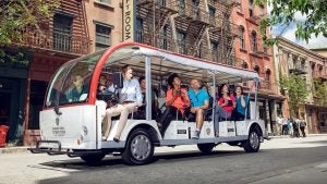 a group of people in a tour trolley