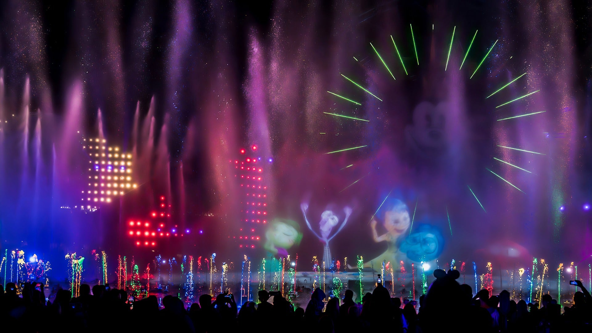 a spectacular lights show with water fountains and people watching