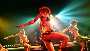 a group of girls in costumes performing on stage