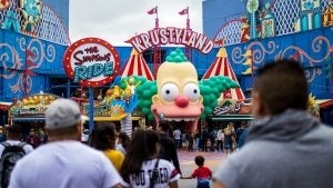 a clown head as a ride entrance with people entering