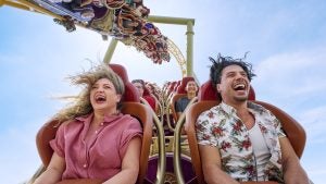 a roller coaster with people happily enjoying the ride