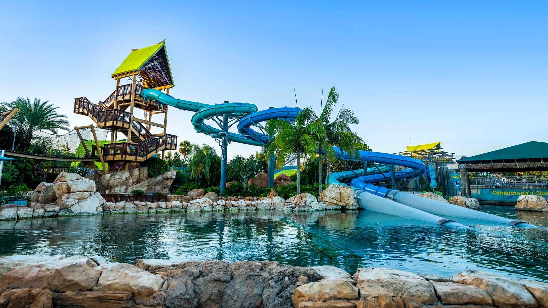 a water park with slides and a tower to climb, pool below