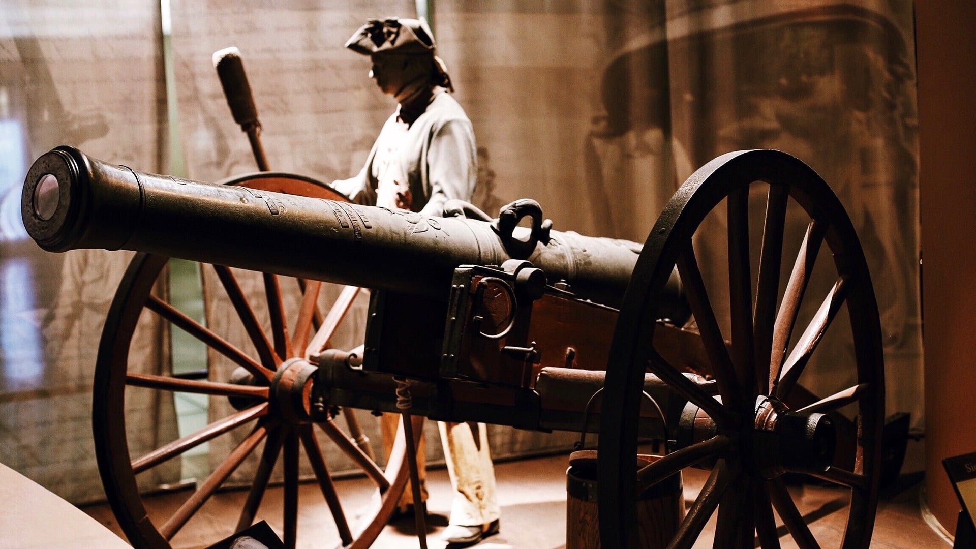 a museum display of a war cannon with a soldier