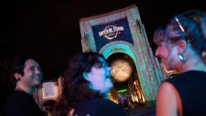 Guests gathered outside the Universal Studios Florida entrance arch decorated for Halloween Horror Nights
