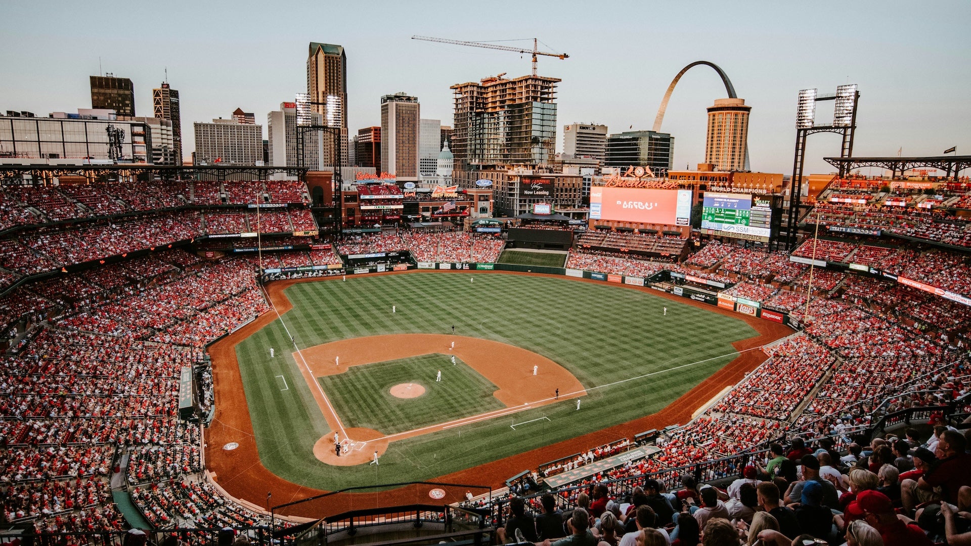Aerial view of a mlb stadium with downtown and the gateway arch in the background