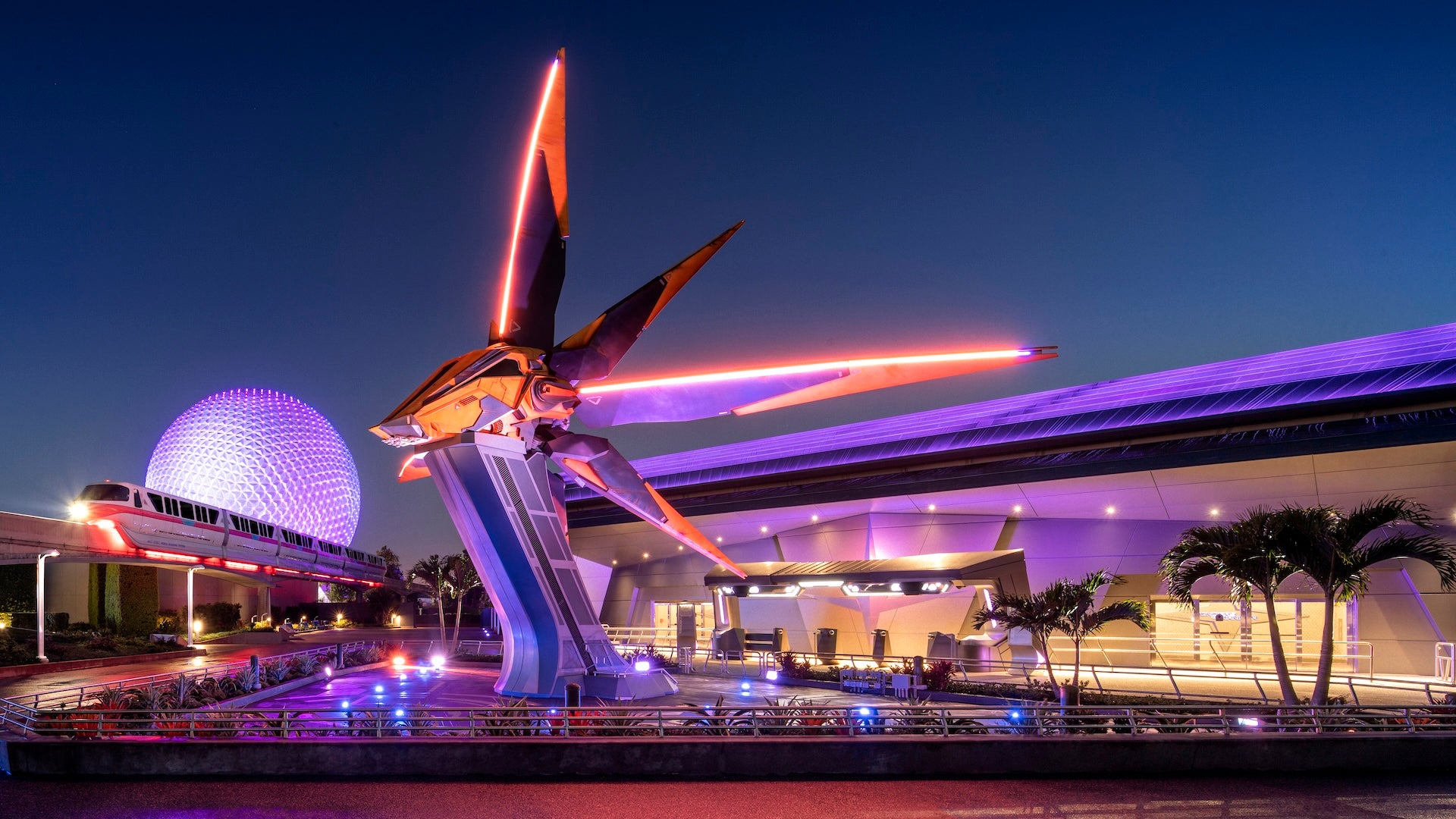 Space ship at the entrance to Guardians at night with the monorail and Spaceship earth in the background