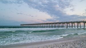 Ocean with dock under a twilight sky