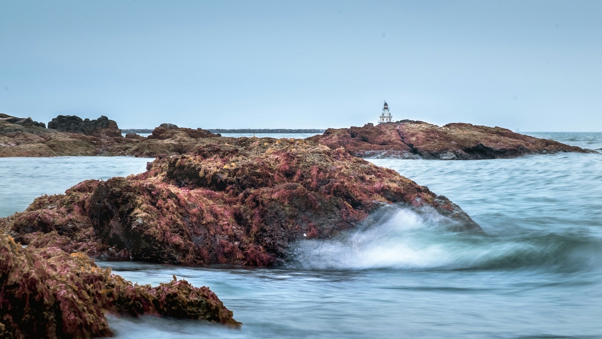 Brown rock formations surrounded by sea water