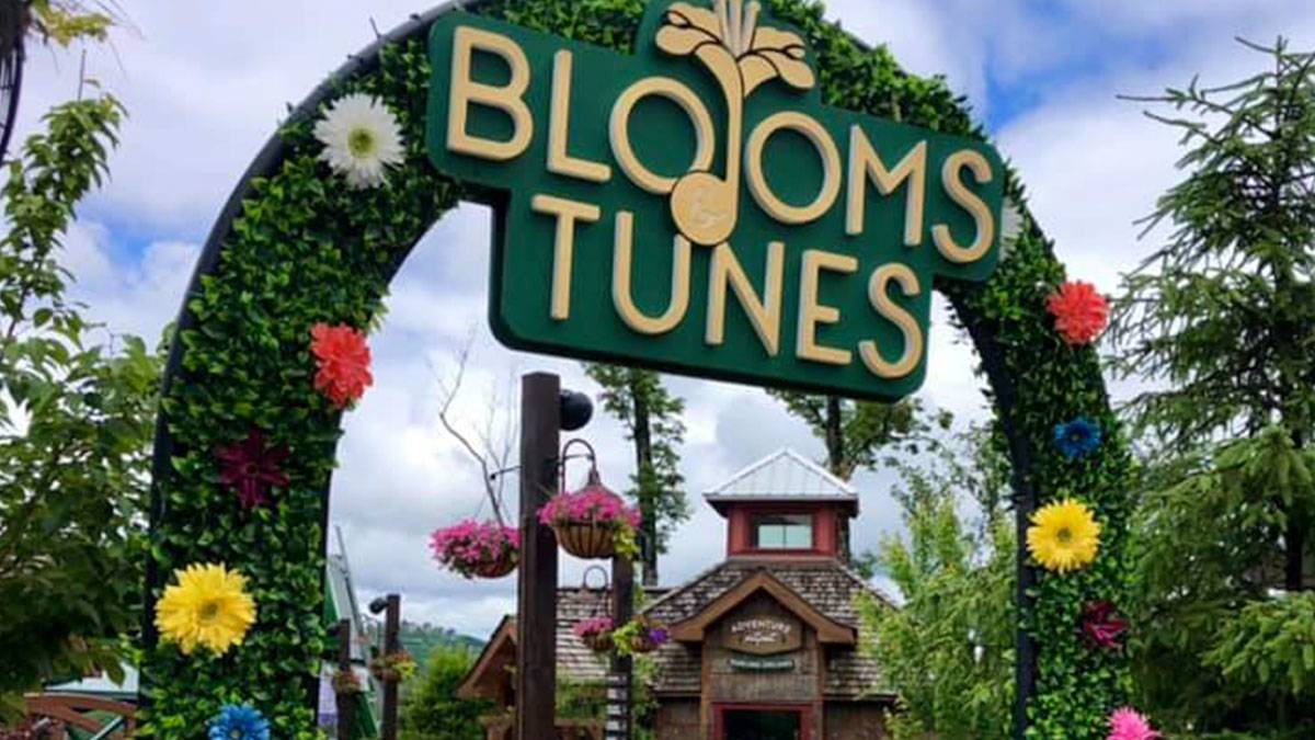 Blooms and Tunes sign decorated with leaves and flowers