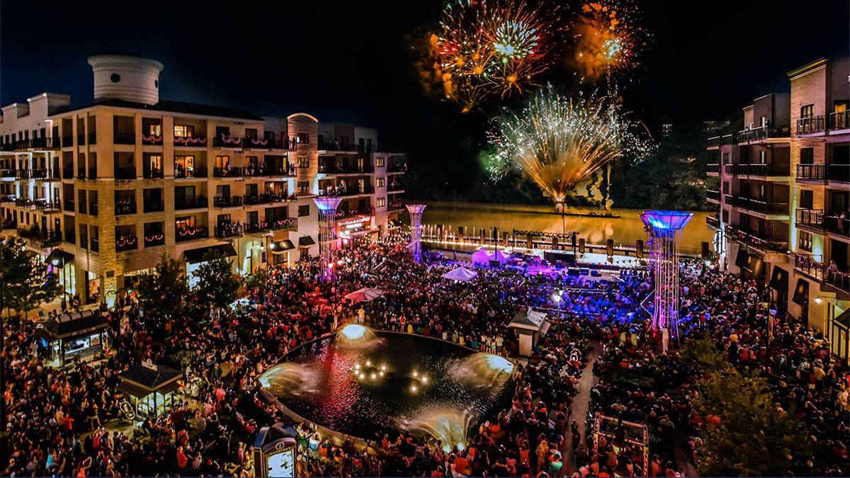 a fireworks in display in a concert full of people