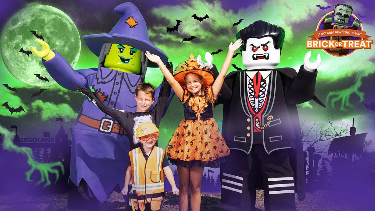 children in halloween costumes beside witch and vampire lego characters for Brick or Treat at Legoland in New York City, New York, USA