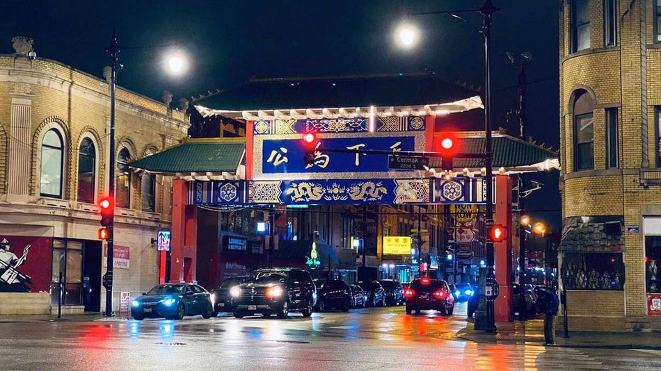 nightshot of cars passing under the Chicago Chinatown Gate in Chinatown, Chicago, Illinois, USA