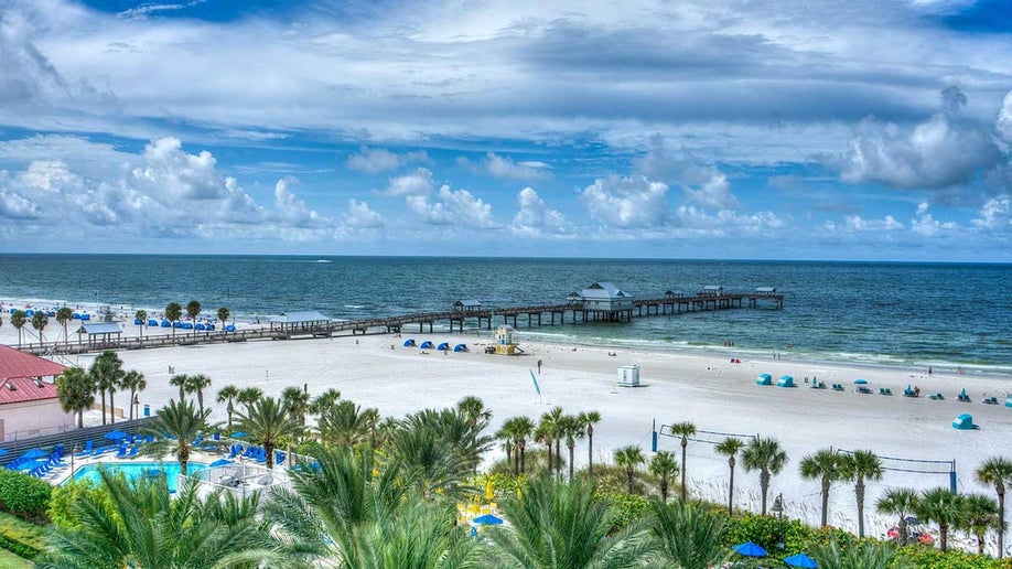 aerial view of Clearwater Beach in Florida, USA with view of water and shore and palm trees and blue sky with clouds