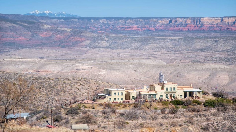 Douglas Mansion in the middle of desert lands with mountains in the background in Arizona, USA