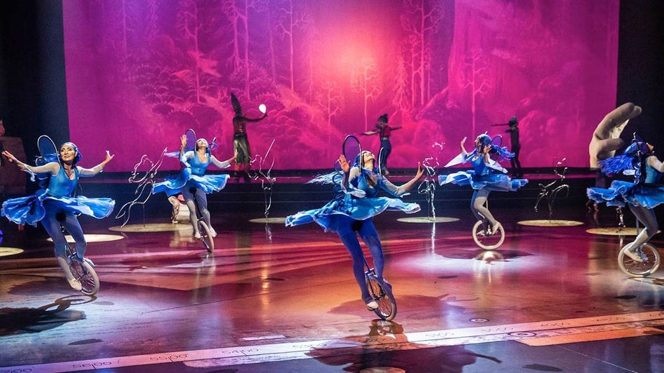 performers on unicycles on stage for the production of Drawn to Life by Cirque du Soleil + Disney in Florida, USA