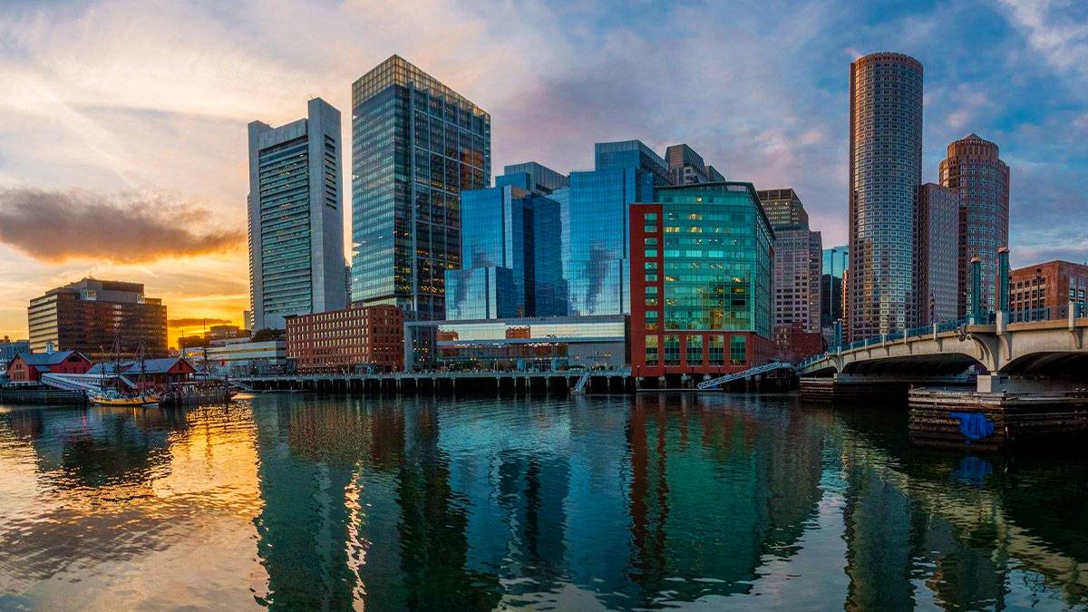 fort point channel during sunset with buildings, bridge and view of water in Boston, Massachusettes, USA