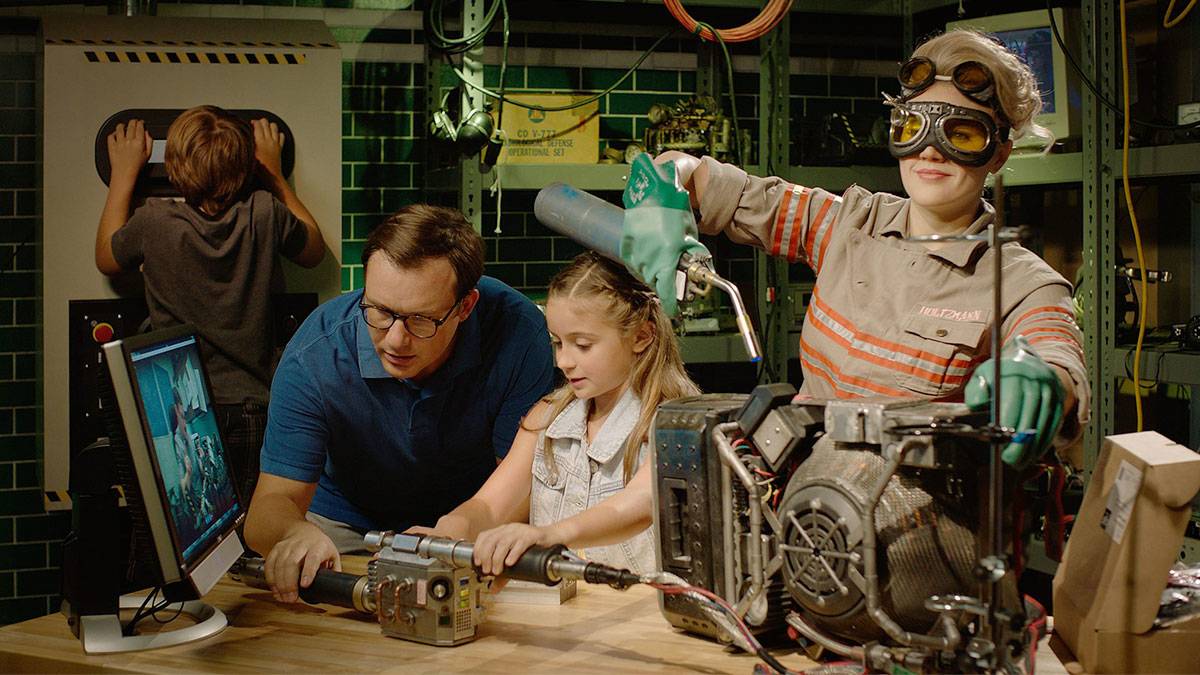 a picture of a family tinkering a machine in a laboratory