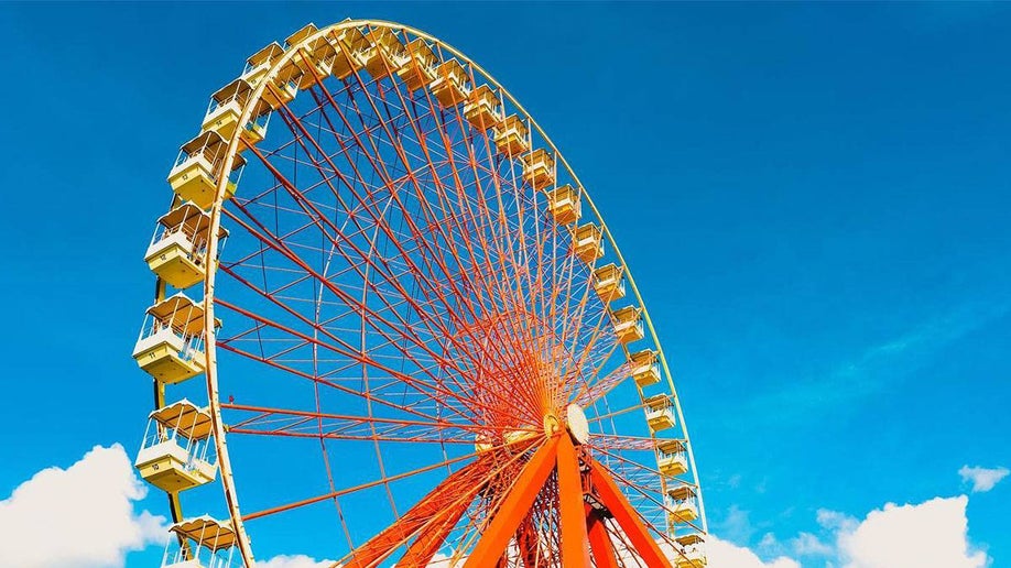 Giant Wheel ride with blue sky and clouds in the back ground in Kentucky Kingdom, Louisville, Kentucky, USA