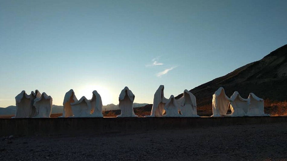 ghostly statues on a platform that are part of the Goldwell Open Air Museum in Ryolite Ghost Town, Nevada, USA
