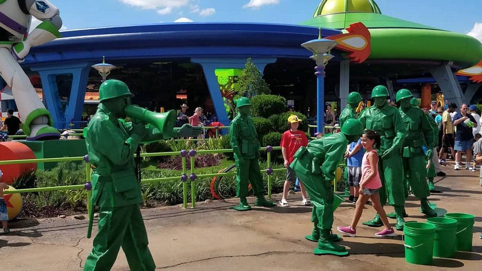 Green Army Patrol performers interacting with a child at Disney's Hollywood Studios in Disneyworld, Orlando, Florida, USA
