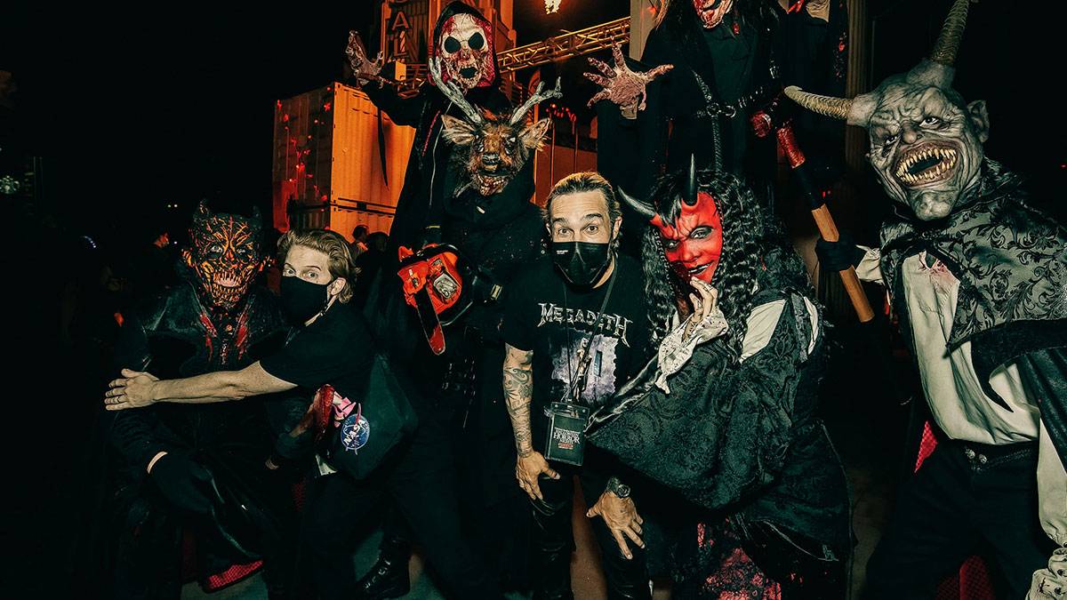 guests posing with performers in costume at Halloween Horror Nights Universal Studios Hollywood in Los Angeles, California, USA