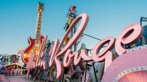 angled shot of neon pink sign of Moulin Rouge Hotel with Hard Rock cafe guitar logo in the background in Las Vegas, Nevada, USA