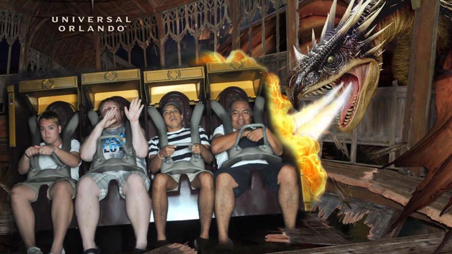 photo of people aboard the Harry Potter and the Forbidden Journey ride with Dragon blowing fire on the side of the photo in Wizarding World of Harry Potter, Universal Studios,Orlando, Florida, USA