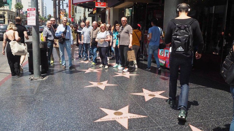 People standing and walking on Hollywood Blvd Walk of Fame - Los Angeles, California, USA