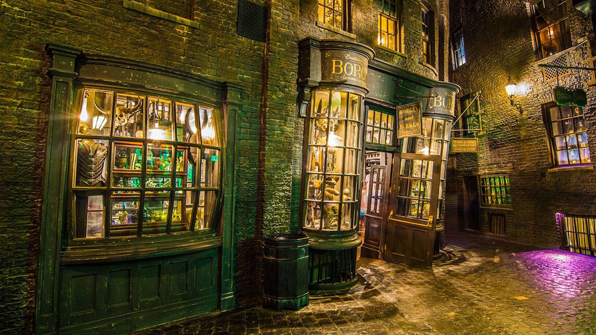 exterior of shop during nighttime with colorful lighting in Knockturn Alley in The Wizarding World of Harry Potter, Orlando, Florida, USA