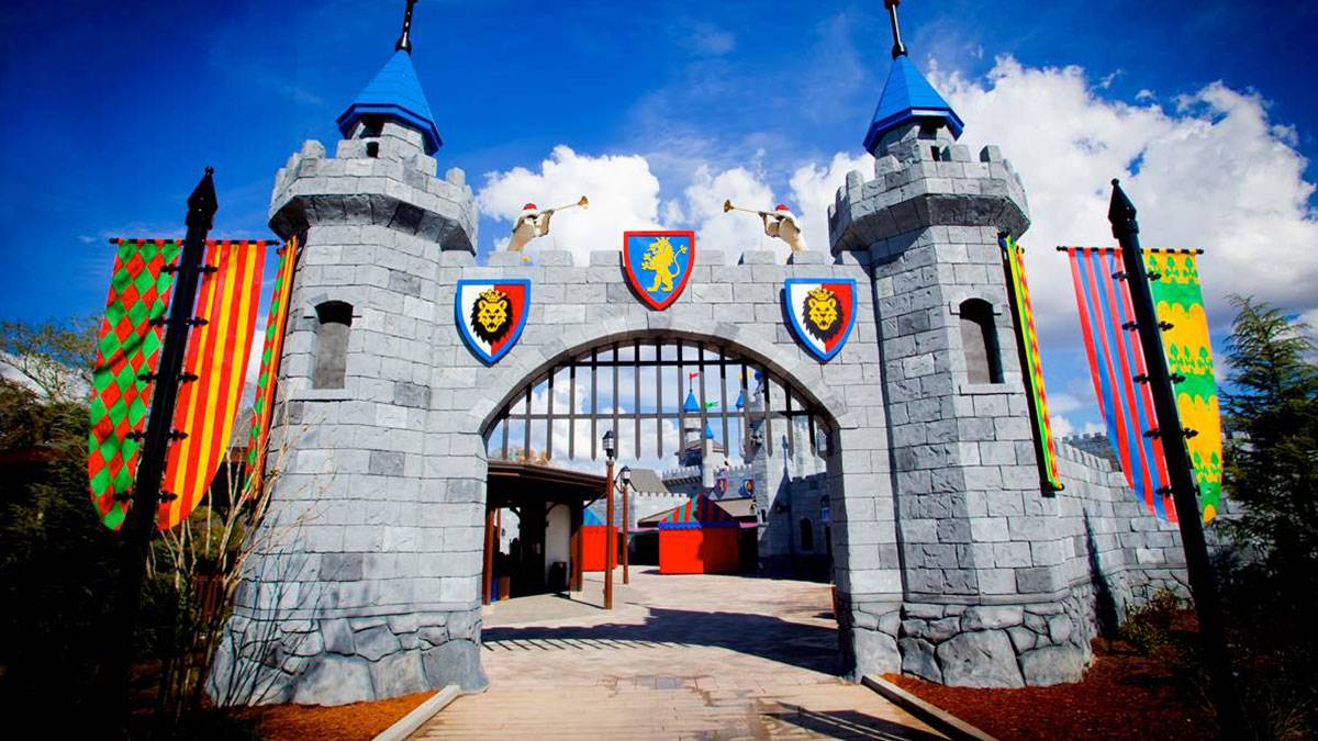 entrance to Legoland New York's Castle decorated with brightly colored banners and flags on a sunny day in New York, USA