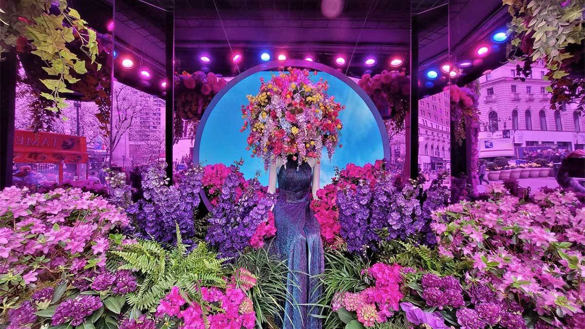 manequin in purple dress with flowers on head surrounded by flowers for Macy's Flower Show in New York City, New York, USA
