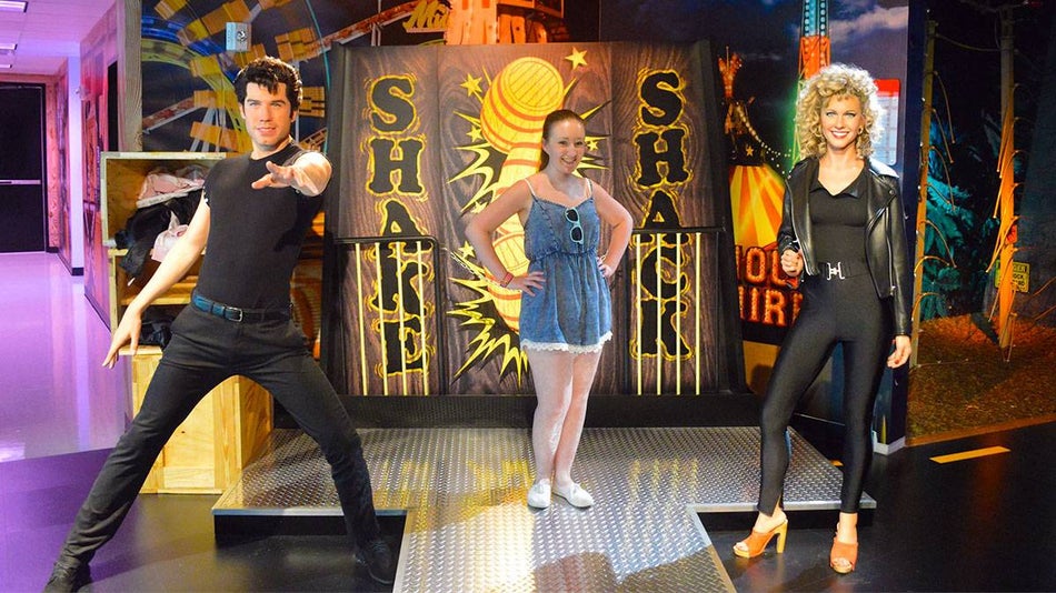 guest posing for photo between two wax figures at Madame Tussauds Orlando, Orlando, Florida, USA