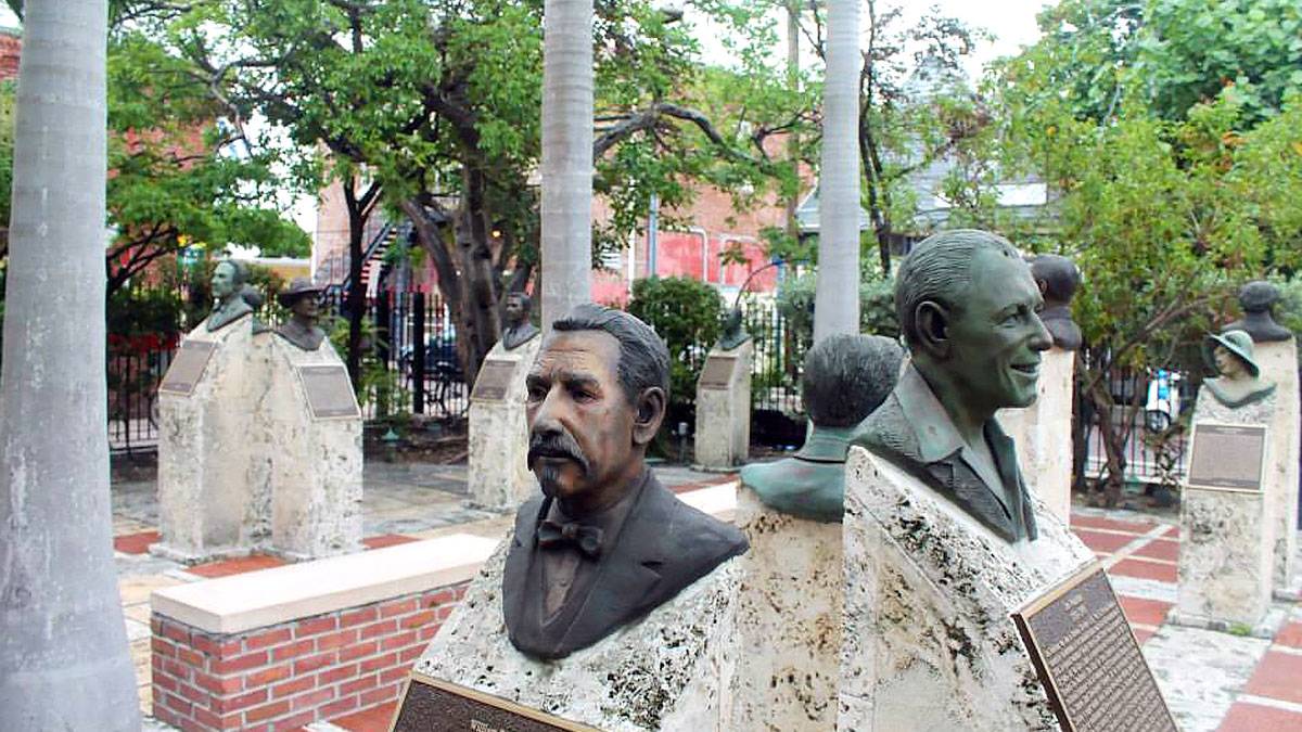 busts at Memorial Sculpture Garden Mallory Square with plants and trees in background in Key West, Florida, USA