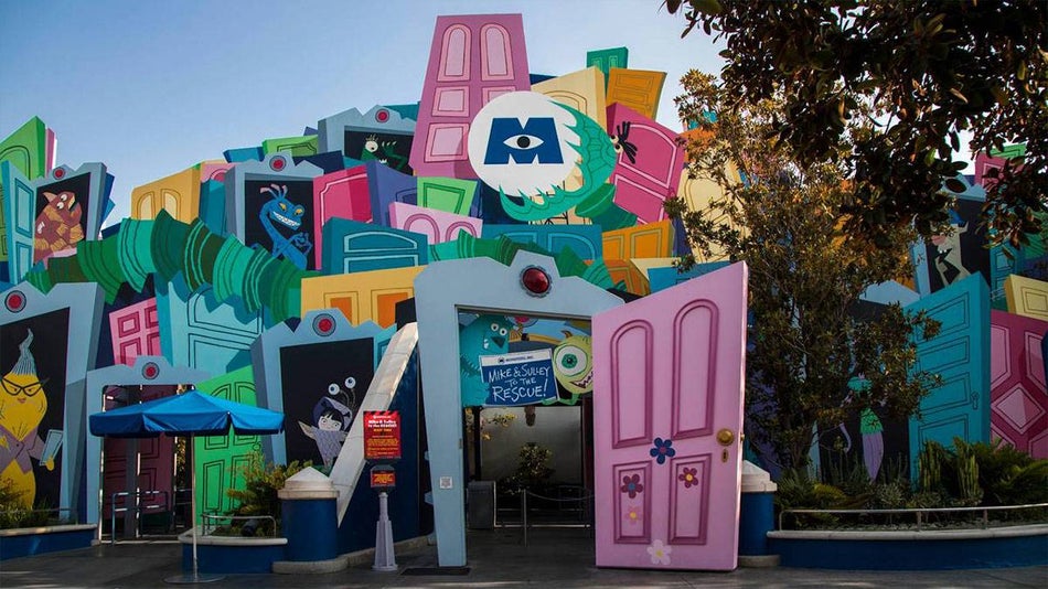 colorful entrance to the Monsters Inc. Mike and Sulley to the Rescue attraction in Disneyland, Anaheim, California, USA with plants and trees on the side