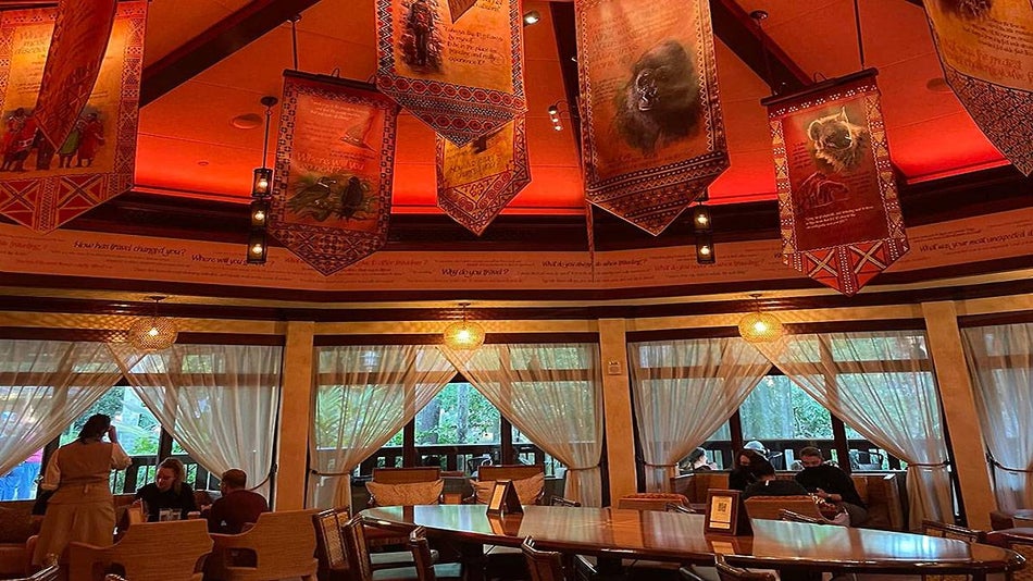 interior of Nomad Lounge with flags hanging from ceiling and people dining at Disneyworld in Orlando, Florida, USA