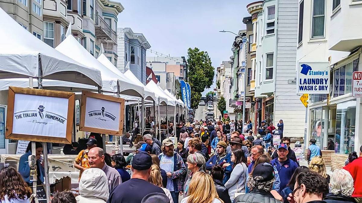 crowd of people on street looking at stalls for North Beach Festival during daytime in San Francisco, California, USA