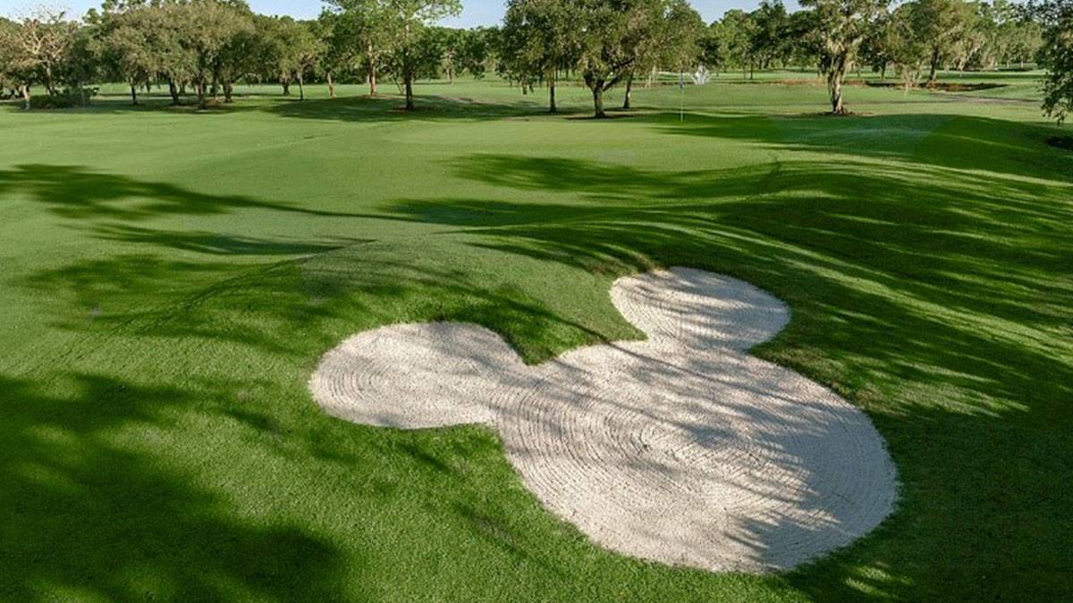 mickey mouse shaped sand pit in Palm Colf Course with trees in the background in Disney World, Orlando, Florida