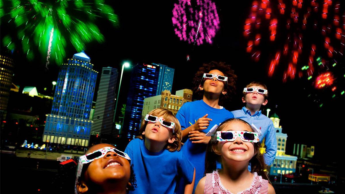 children wearing glasses while viewing fireworks for Red White and Boom at Legoland in New York City, New York, USA