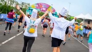 people in costumes running towards the finish line for Run Disney Springtime Surprise Run in Disneyland, Anaheim, California, USA