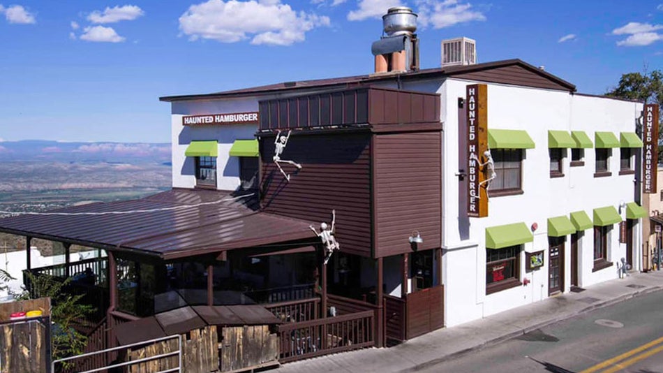 exterior of Haunted Hamburger restaurant during daytime with skelleton decorations in Jerome, Arizona, USA