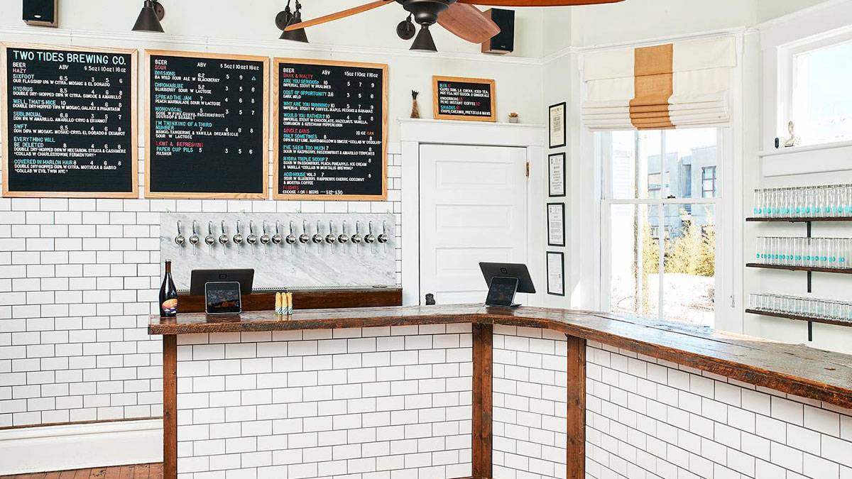 counter at Two Tides Brewing Company decorated with wood and white tiles