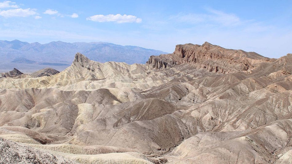 rock formation Zabriskie Point during the daytime with blue sky and clouds in Death Valley, Las Vegas, Nevada, USA