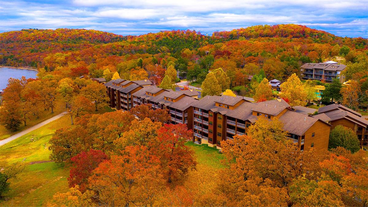 Aerial view of the Still Waters Condominium Resort in the fall surrounded by trees with bright fall colors in Branson, Missouri, USA