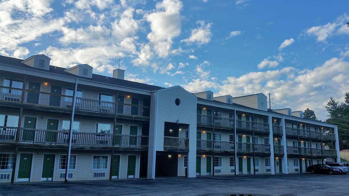 Ground view looking up at the White Wing Lodge with a bright blue cloudy sky behind it in Branson, Missouri, USA