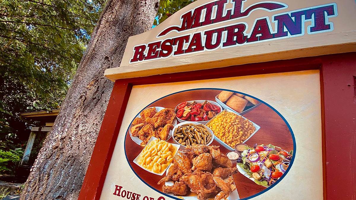 Close up of the sign for Molly's Mill Restaurant with a photo of the food they offer there in the middle at Silver Dollar City in Branson, Missouri, USA