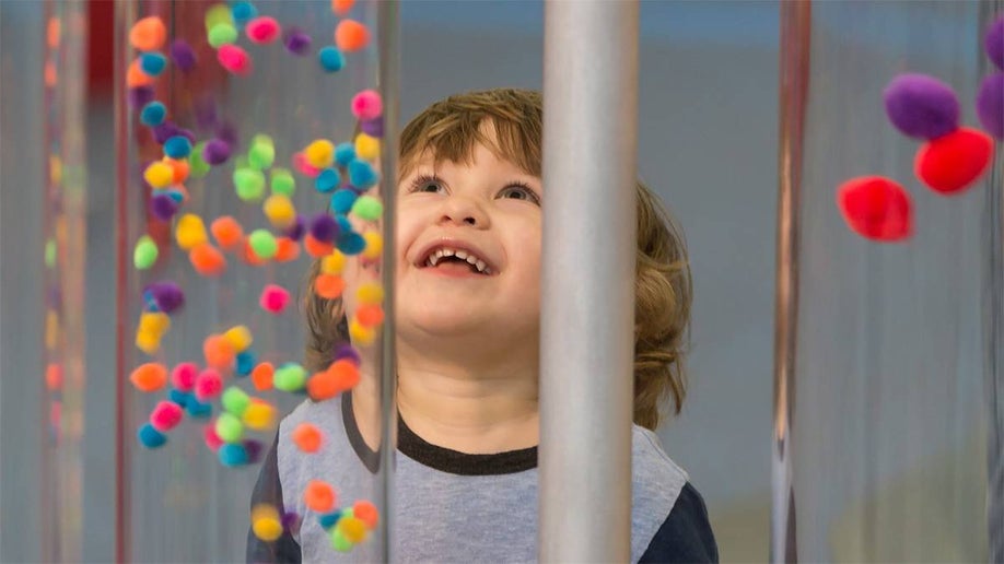 Close up photo of a toddler looking up at an exhibit at DuPage Children's Museum in Chicago, Illinois, USA