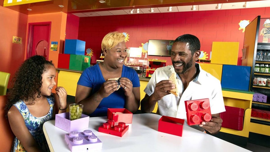 Close up of a family eating out of LEGO boxes at the LEGO Cafe at the LEGOLAND Discovery Center in Chicago, Illinois, USA