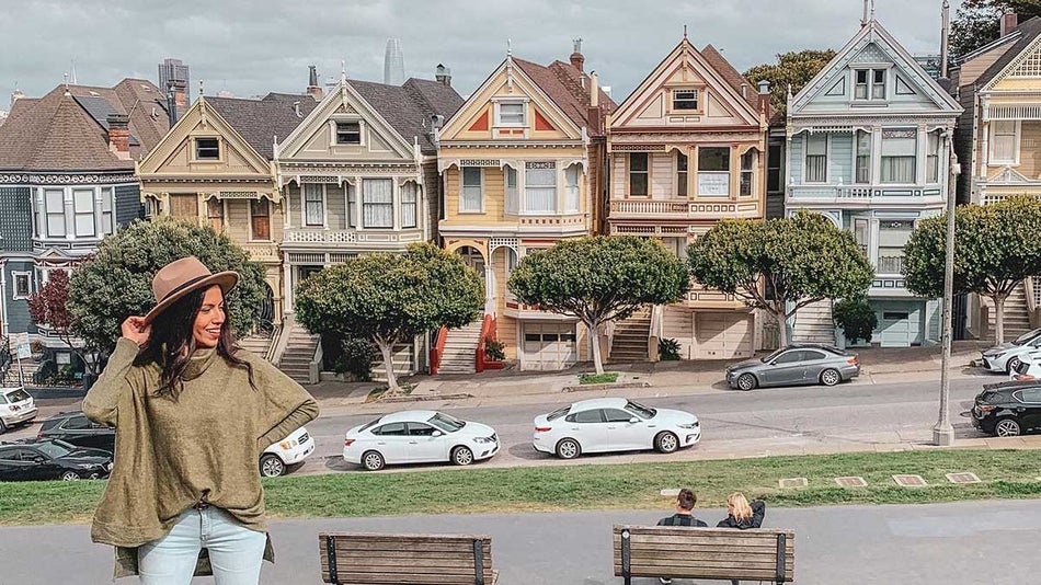 woman posing in front of house used for the show Full House in San Francisco, California, USA