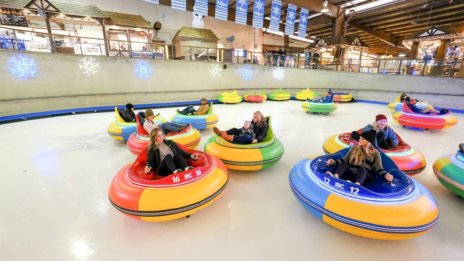 Wide shot of people in brightly colored ice bumper cars on the skating rink at Ober Gatlinburg in Gatlinburg, Tennessee, USA