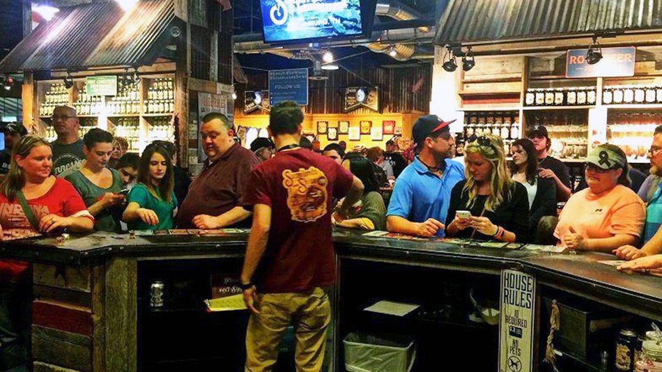 nterior view of the bar with a crowd of people at Sugarlands Distilling Company in Gatlinburg, Tennessee, USA